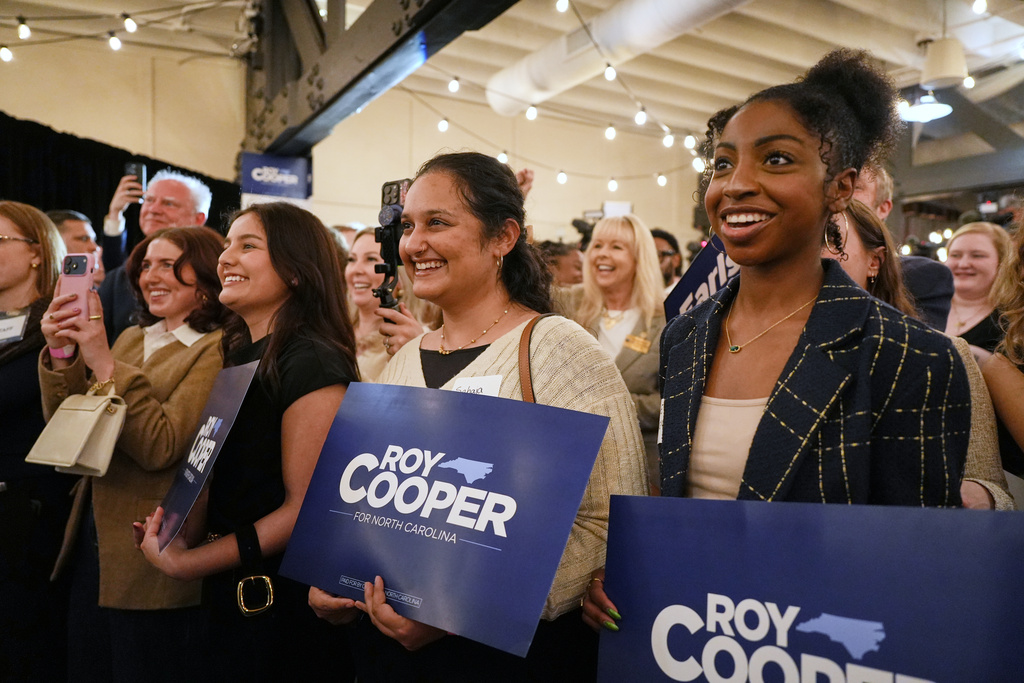 Supporters of North Carolina Democratic Senate candidate former Gov. Roy Cooper watch as he speaks at a primary election night watch party Tuesday, March 3, 2026, in Raleigh, N.C. (AP Photo/Matt Ramey)
