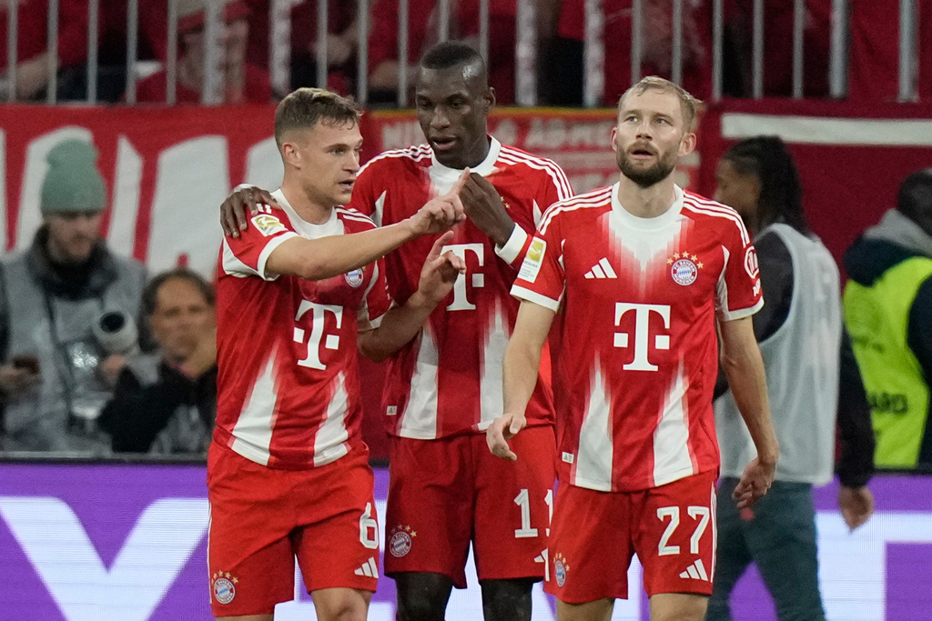 Bayern's Nicolas Jackson, center, celebrates after scoring his side's second goal during the German Bundesliga soccer match between Bayern Munich and Bayern Leverkusen in Munich, Germany, Saturday, Nov. 1, 2025. (AP Photo/Matthias Schrader)