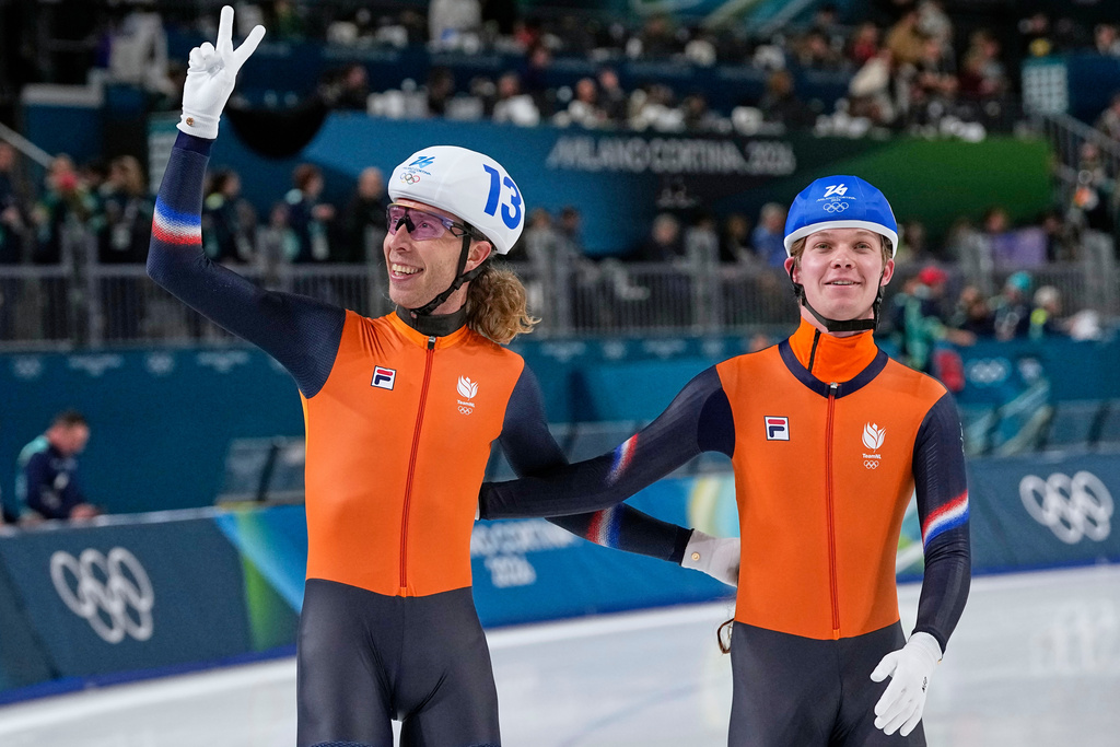 Jorrit Bergsma of the Netherlands, left, celebrates winning the gold medal with his teammate Stijn van de Bunt, right, after the men's mass start final speedskating race at the 2026 Winter Olympics, in Milan, Italy, Saturday, Feb. 21, 2026. (AP Photo/Ben Curtis)
