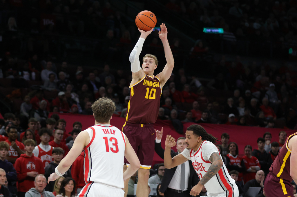 FILE - Minnesota guard Cade Tyson, center, shoots between Ohio State center Christoph Tilly, left, forward Devin Royal during an NCAA college basketball game in Columbus, Ohio, on Jan. 20, 2026. (AP Photo/Paul Vernon, File)