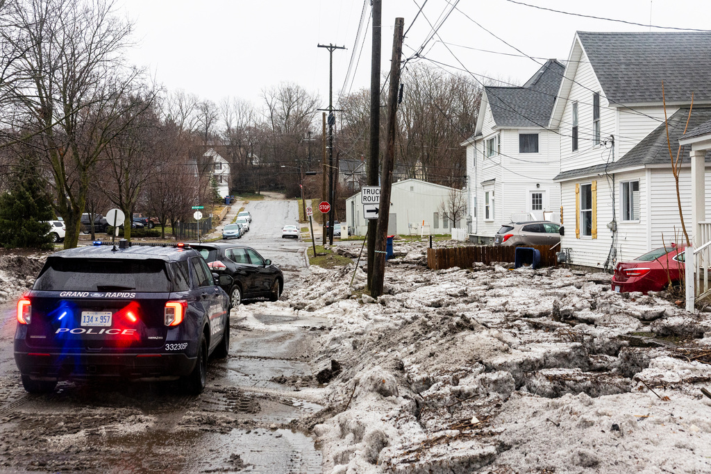 Debris and piles of hail cover a street after flash flooding in Belknap Lookout neighborhood on the Northeast side of Grand Rapids, Mich. on Wednesday, March 11, 2026. (Joel Bissell/Kalamazoo Gazette via AP)