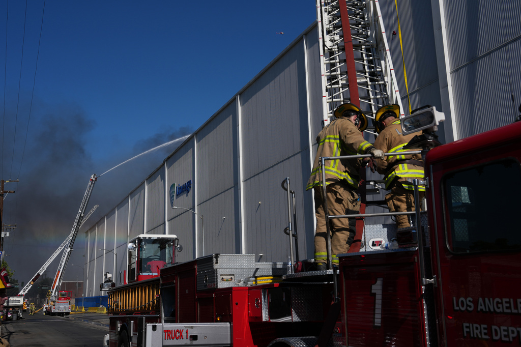 Crews work a warehouse fire in the Boyle Heights section of Los Angeles on Wednesday, June 17, 2026. (AP Photo/Jae C. Hong)