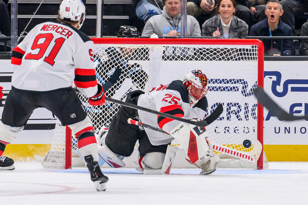 New Jersey Devils goaltender Jacob Markstrom (25) makes a stick save during the second period of an NHL hockey game against the Utah Mammoth, Friday, Dec. 19, 2025, in Salt Lake City. (AP Photo/Tyler Tate)