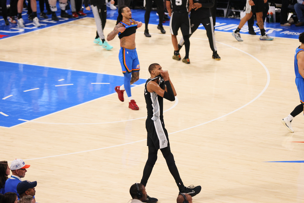 San Antonio Spurs forward Victor Wembanyama (1) celebrates while Oklahoma City Thunder forward Jaylin Williams walks off court as time expires in the second half of Game 7 of the Western Conference finals of the NBA basketball playoffs series Saturday, May 30, 2026, in Oklahoma City. (AP Photo/Nate Billings)