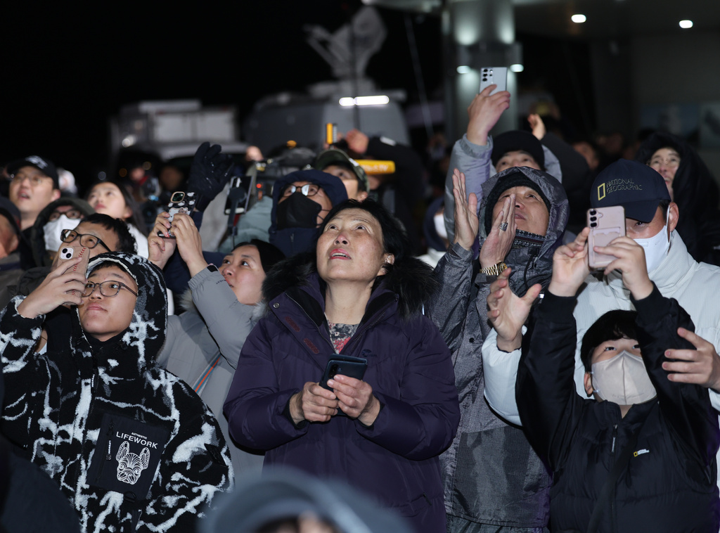 People watch the Nuri rocket taking off from the launch pad near the Naro Space Center in Goheung, South Korea, Thursday, Nov. 27, 2025. (Kim Hea-in/Yonhap via AP)
