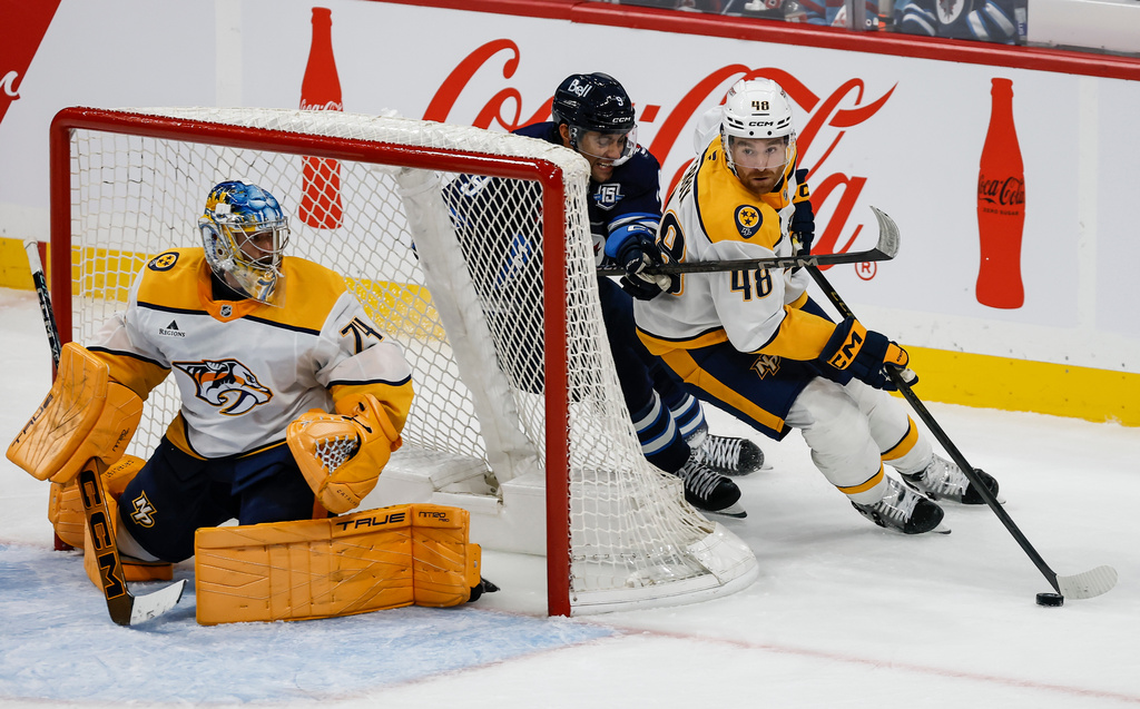 Winnipeg Jets' Alex Iafallo (9) chases Nashville Predators' Nick Perbix (48) as Predators goaltender Juuse Saros (74) watches during second-period NHL hockey game action in Winnipeg, Manitoba, Saturday, Oct. 18, 2025. (John Woods/The Canadian Press via AP)