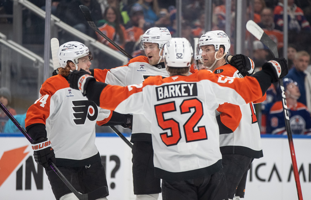 Philadelphia Flyers' Owen Tippett (74), Travis Sanheim (6), Denver Barkey (52) and Travis Konecny (11) celebrate a goal against the Edmonton Oilers during the first period of an NHL hockey game, in Edmonton, Saturday, Jan. 3, 2026. (Jason Franson/The Canadian Press via AP)