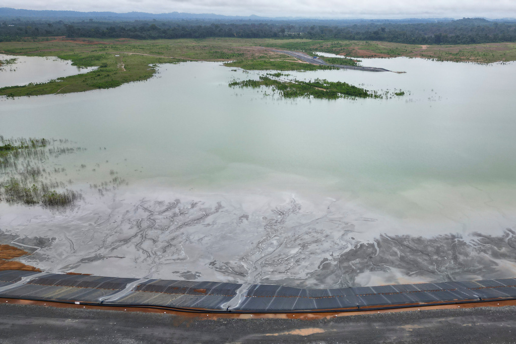 An aerial view shows mining waste flowing into a large pond at an inland location east of Grand Cape Mount, not far from the Mano River in Liberia, July 9, 2025. (AP Photo/Misper Apawu)
