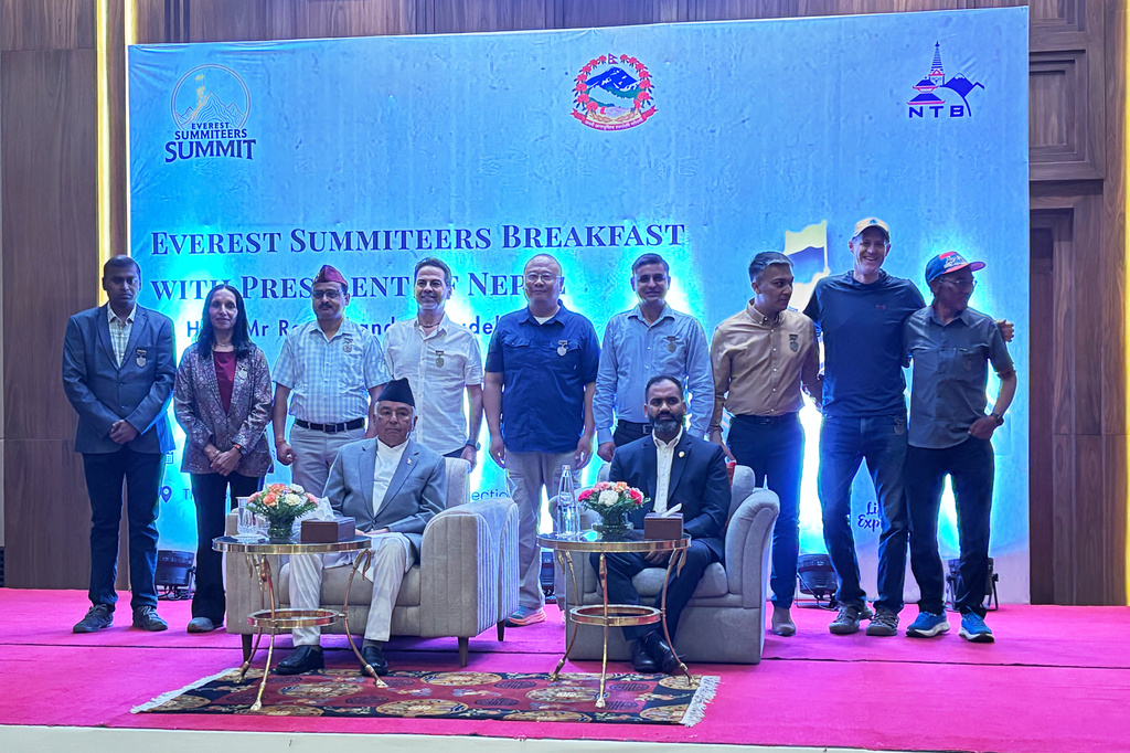 Everest climbers pose with Nepal's President Ram Chandra Poudel, seated left, and Nepal's Tourism Minister Khadak Raj Paudel during the 'Everest Summiteers Summit' in Kathmandu, Nepal, Wednesday, May 27, 2026. (AP Photo/Upendra Man Singh)