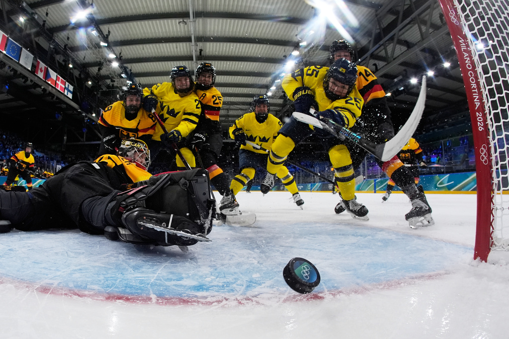 Sweden's Lina Ljungblom, center right, scores her sides opening goal during a preliminary round match of women's ice hockey between Germany and Sweden at the 2026 Winter Olympics, in Milan, Italy, Thursday, Feb. 5, 2026. (AP Photo/Petr David Josek, Pool)