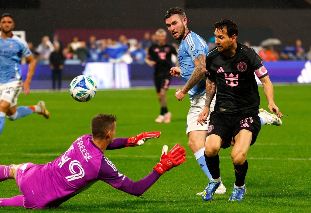 Inter Miami forward Lionel Messi (10) scores a goal against New York City FC goalkeeper Matt Freese (49) midfielder Aiden O'Neill during the second half of a MLS soccer game, Wednesday, Sept. 24, 2025, in New York. (AP Photo/Noah K. Murray)