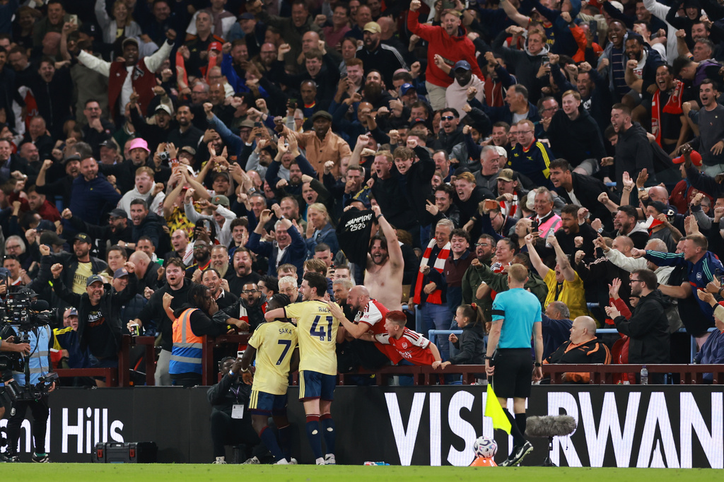 Arsenal's Bukayo Saka (7) celebrates with team mate Arsenal's Declan Rice after scoring his side's opening goal during the English Premier League soccer match between Aston Villa and Arsenal in Birmingham, England, Monday, Aug. 31, 2026. (AP Photo/Morgan Harlow)