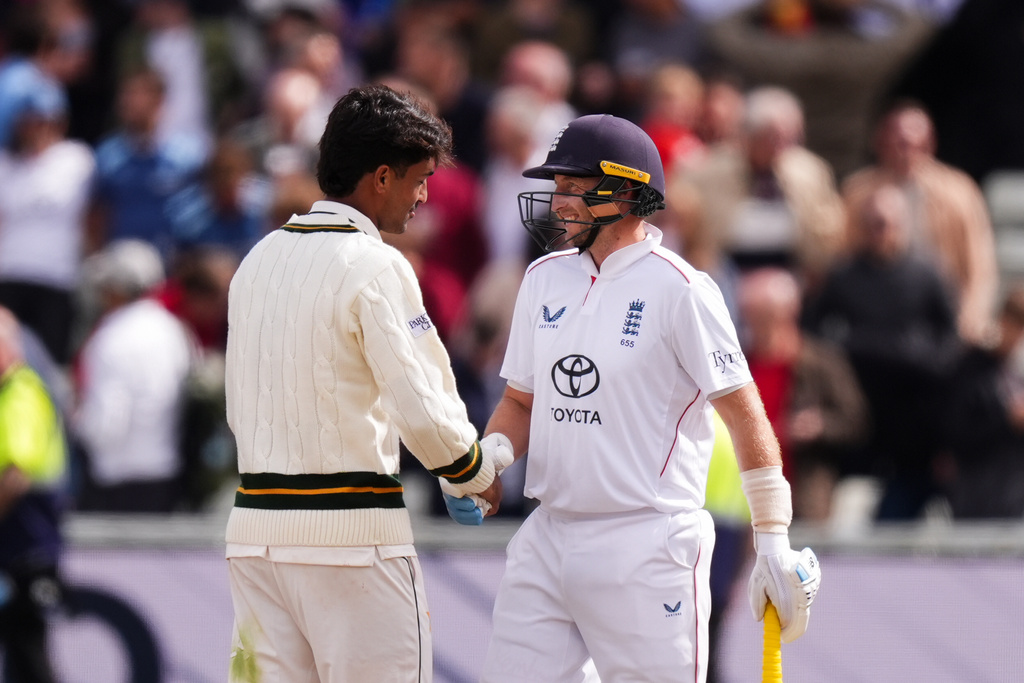 England's Joe Root and Pakistan's Razaullah shake hands following England's victory on day four of the third cricket Test at Edgbaston, in Birmingham, England, Saturday, Sept. 12, 2026. (Mike Egerton/PA via AP)
