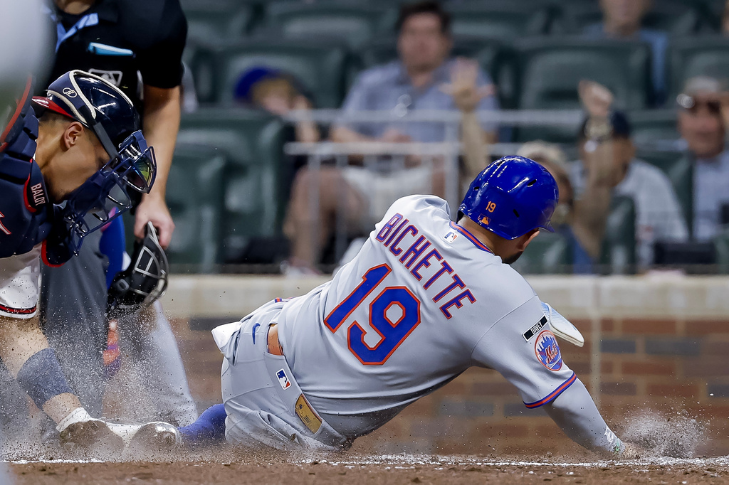 Atlanta Braves catcher Drake Baldwin, left, tags out New York Mets' Bo Bichette (19) at home plate during the sixth inning of a baseball game, Monday, July 6, 2026, in Atlanta. (AP Photo/Erik S. Lesser)