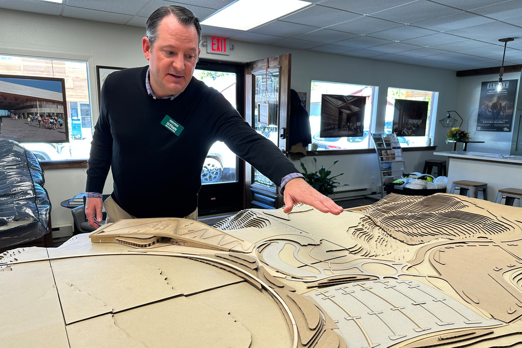 Theodore Roosevelt Presidential Library Foundation CEO Ed O'Keefe gestures to a model of the library and surrounding landscape at the library's office in Medora, N.D., Tuesday, Oct. 7, 2025. (AP Photo/Jack Dura)