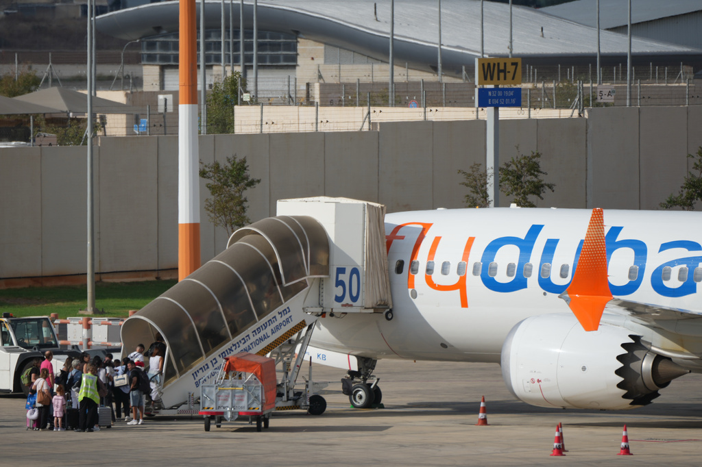 Passengers embark on a FlyDubai aircraft at Ben Gurion International Airport, near Tel Aviv, Israel, Wednesday, Sept. 30, 2026. (AP Photo/Ariel Schalit)