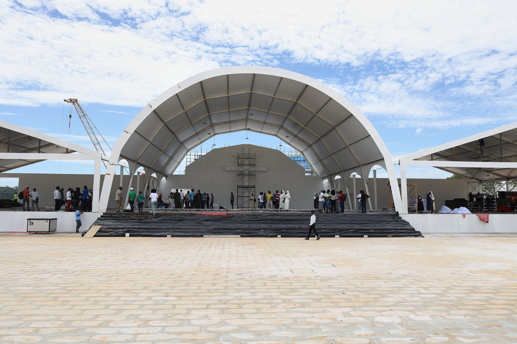 People walk on a stage set by the Church of Our Lady of Muxima in Muxima, Angola, Saturday, April 11, 2026 which Pope Leo XIV will visit during his 11-day pastoral visit to Africa. (AP Photo)
