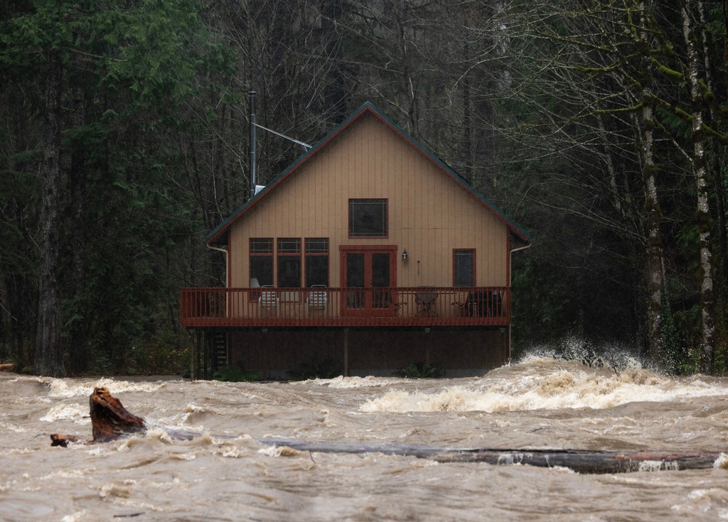The Skykomish River roars by a cabin on Wednesday, Dec. 10, 2025, near Index, Snohomish County, Wash. (Nick Wagner /The Seattle Times via AP)