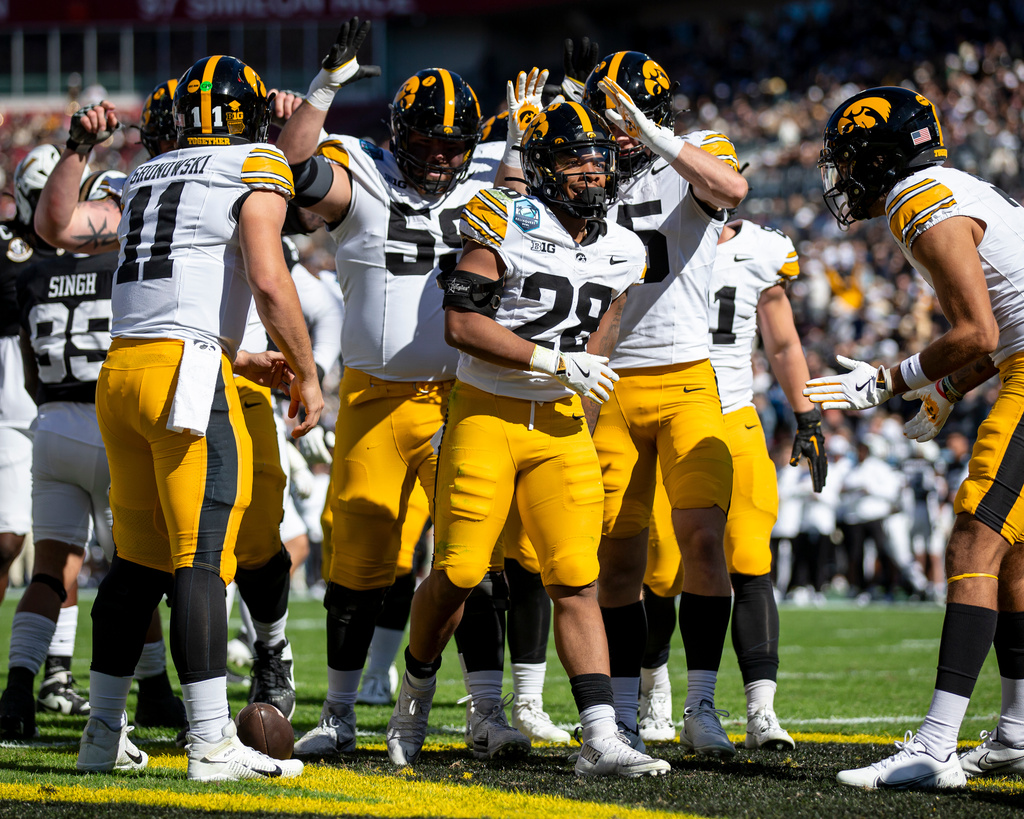 Iowa Hawkeyes running back Kamari Moulton (28) celebrates with teammates after rushing for a touchdown during the 2025 ReliaQuest Bowl game between the Vanderbilt Commodores and the Iowa Hawkeyes at Raymond James Stadium in Tampa, Fla., on Wednesday, Dec. 31, 2025. (Nick Rohlman/The Gazette via AP)