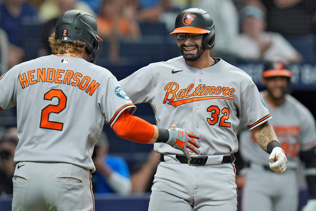 Baltimore Orioles' Christian Encarnacion-Strand (32) celebrates his two-run home run off Tampa Bay Rays pitcher Tyler Wells with Gunnar Henderson (2) during the fifth inning of a baseball game Monday, Aug. 17, 2026, in St. Petersburg, Fla. (AP Photo/Chris O'Meara)