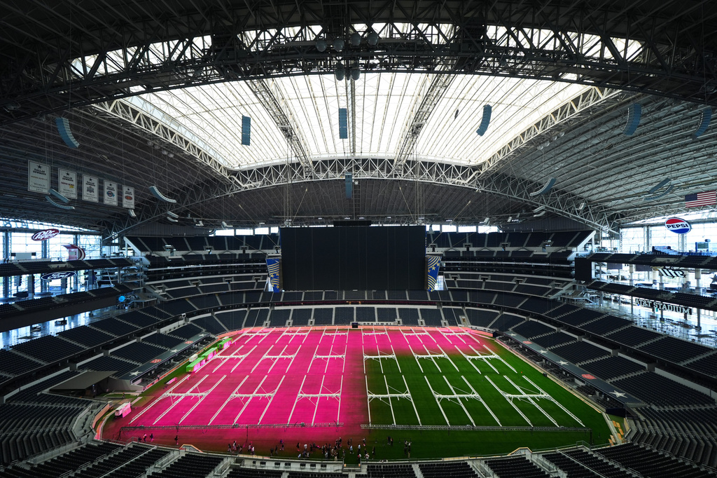 Grow lights illuminate part of the field at AT&T Stadium during a preview of the grass installed at Dallas Stadium, Thursday, May 14, 2026, in Arlington, Texas, ahead of the 2026 FIFA World Cup soccer tournament. (AP Photo/Julio Cortez)