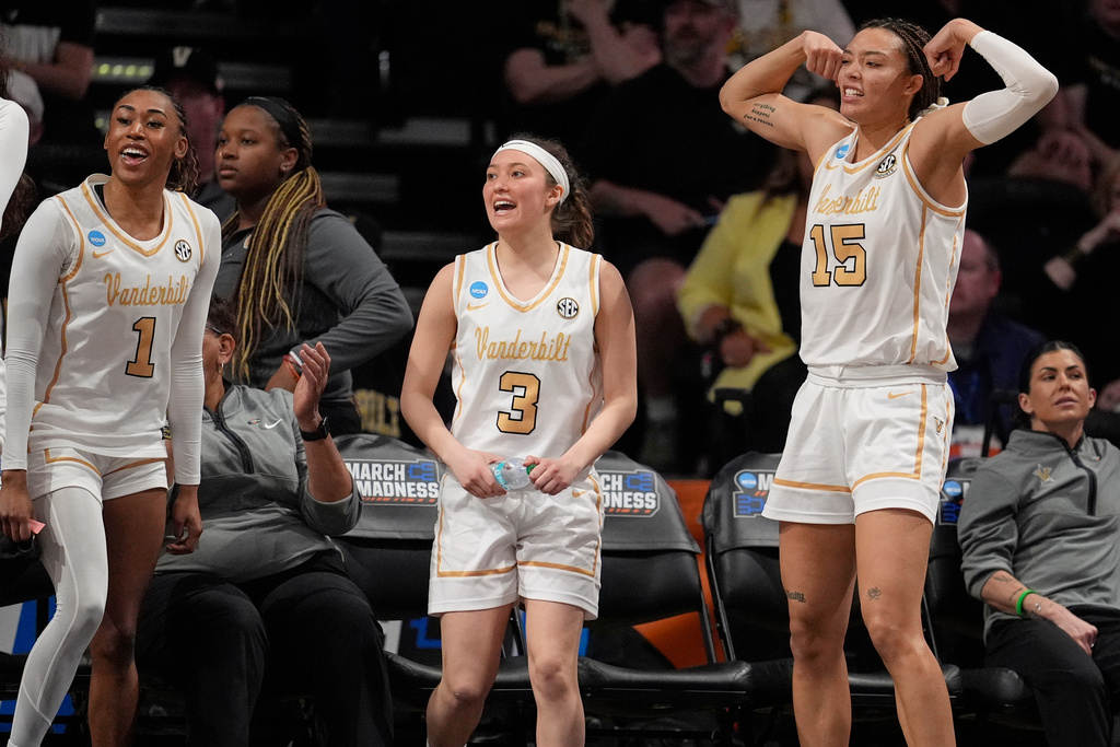 Vanderbilt guards Mikayla Blakes (1), Aubrey Galvan (3) and Ndjakalenga Mwenentanda (15) celebrate on the bench during the second half in the first round of the NCAA college basketball tournament against High Point, Saturday, March 21, 2026, in Nashville, Tenn. (AP Photo/George Walker IV)