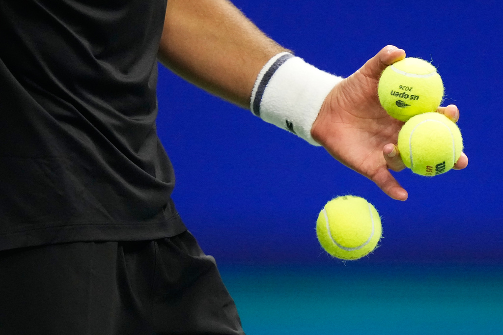 Novak Djokovic, of Serbia, drops a ball as he competes against Mariano Navone, of Argentina, during the first round of the U.S. Open tennis championships Sunday, Aug. 30, 2026, in New York. (AP Photo/Frank Franklin II)