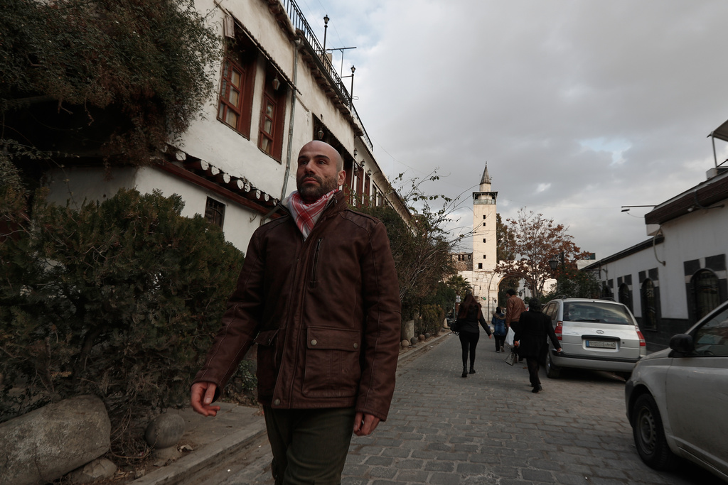 Hani Al Sawah, a Syrian rap artist known as Al Darwish, walks at a street in old Damascus, Syria, Friday, Jan. 16, 2026. (AP Photo/Omar Sanadiki)