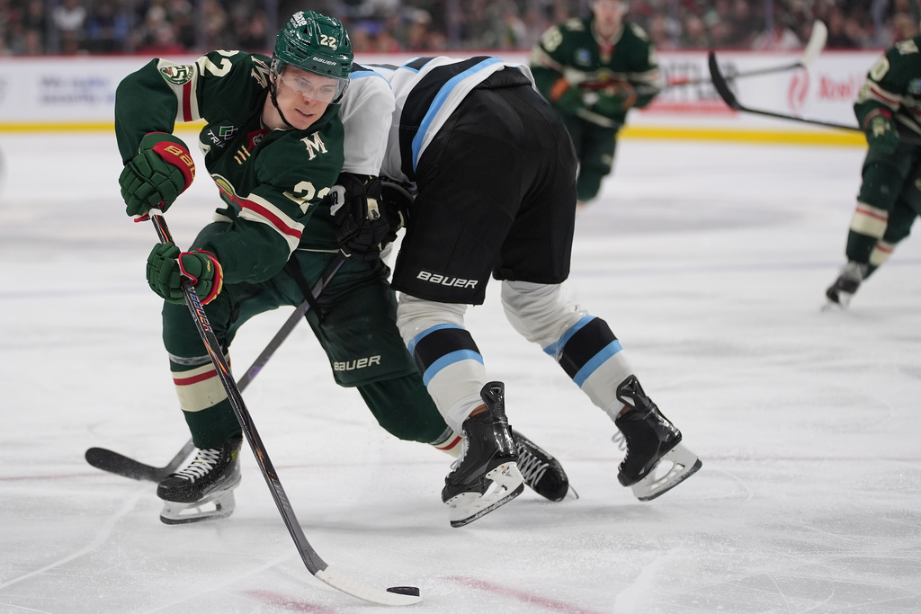 Minnesota Wild right wing Danila Yurov, left, skates with the puck as Utah Mammoth defenseman MacKenzie Weegar defends during the third period of an NHL hockey game, Tuesday, March 10, 2026, in St. Paul, Minn. (AP Photo/Abbie Parr)