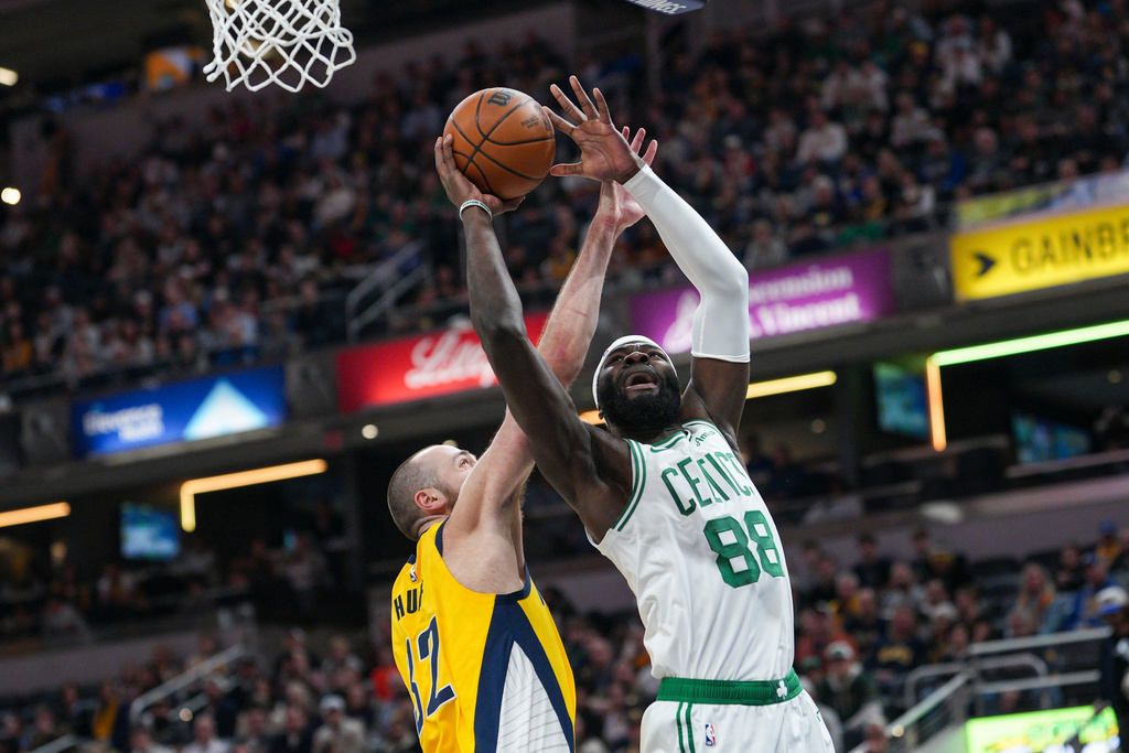 Boston Celtics center Neemias Queta (88) looks to shoot around Indiana Pacers center Jay Huff, left, during the first half of an NBA basketball game in Indianapolis, Friday, Dec. 26, 2025. (AP Photo/AJ Mast)