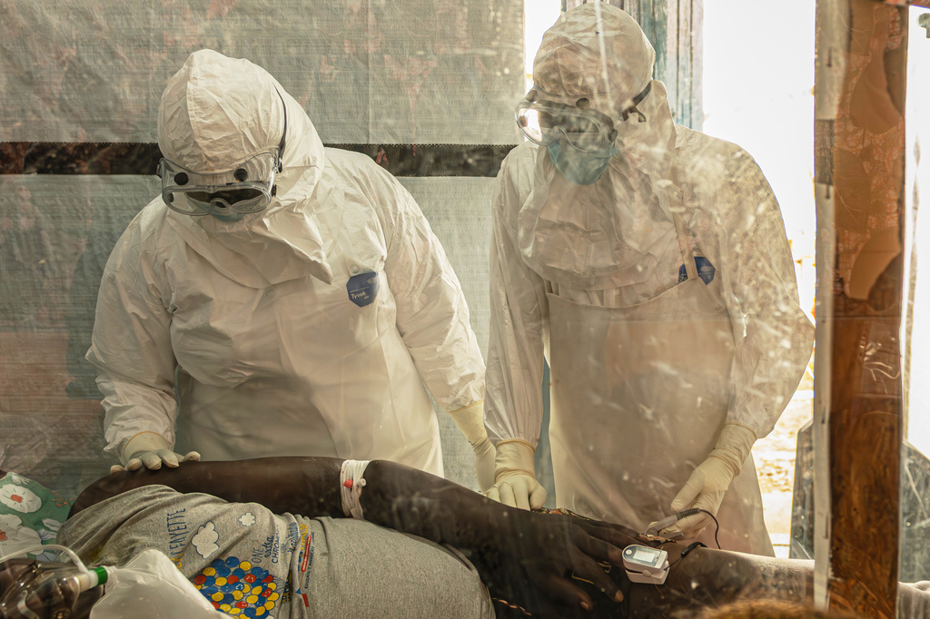 Health workers attend to an Ebola patient at the Rwampara treatment Center in Ituri, Congo, Thursday, June 18, 2026. (AP Photo/Moses Sawasawa)