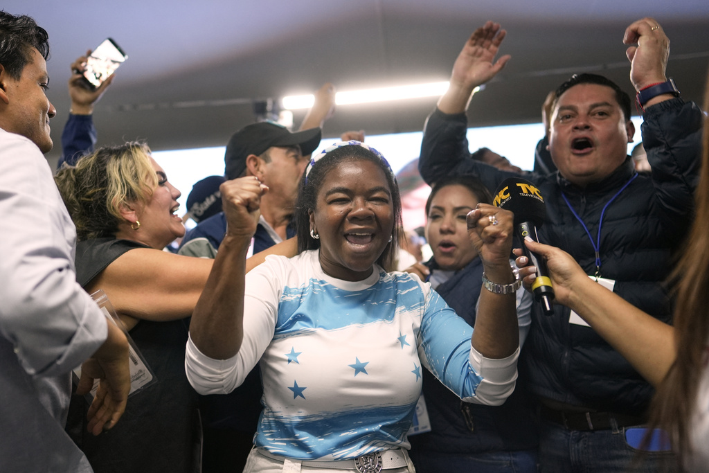 Supporters of presidential candidate Nasry Asfura, of the National Party, celebrate preliminary results during general election in Tegucigalpa, Honduras, Sunday, Nov. 30, 2025. (AP Photo/Emmanuel Andres)