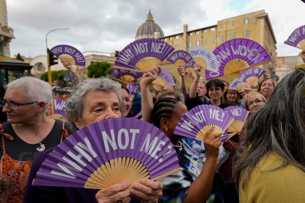FILE - Advocates for women ordination hold banners during a protest in Rome just in front of the Vatican where Pope Francis is holding the Synod of Bishops, Oct. 4, 2024. (AP Photo/Andrew Medichini, file)