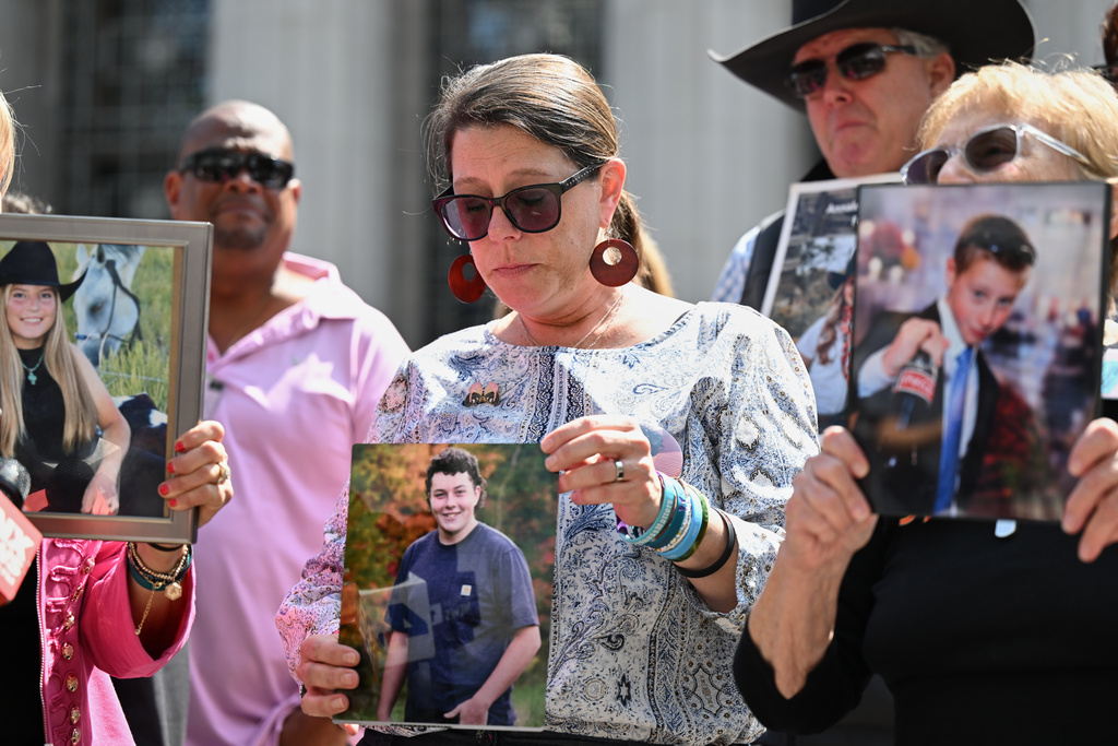 Mary Rodee holds a photo of her son Riley after the verdict in a landmark trial over whether social media platforms deliberately addict and harm children at Los Angeles Superior Court, Wednesday, March 25, 2026, in Los Angeles. (AP Photo/William Liang)
