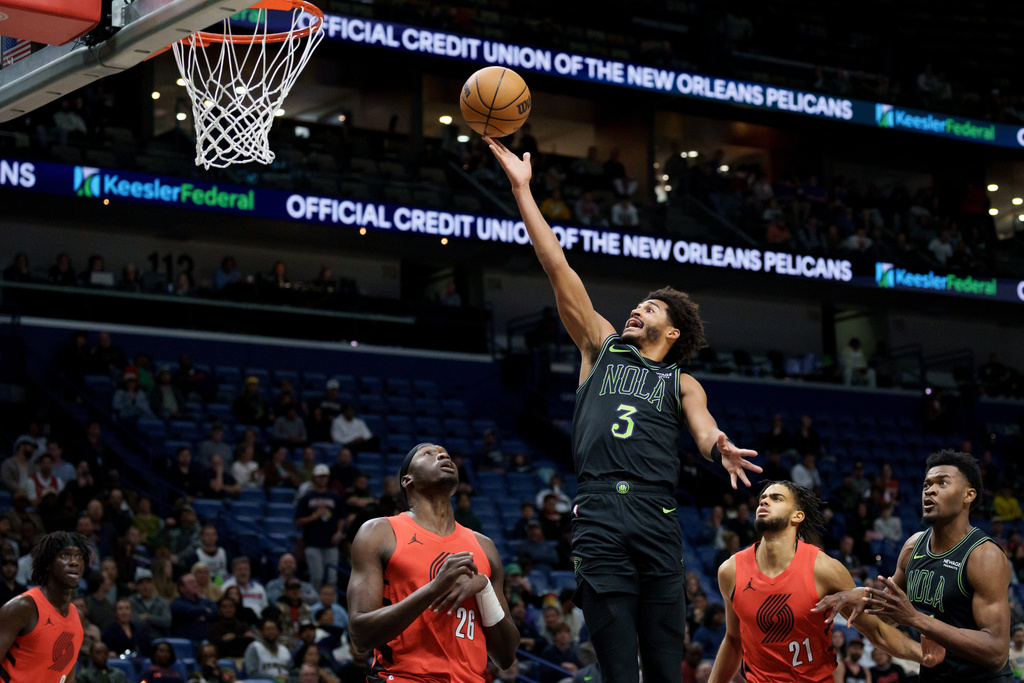 New Orleans Pelicans guard Jordan Poole (3) shoots against Portland Trail Blazers center Duop Reath (26) during the first half of an NBA basketball game in New Orleans, Thursday, Dec. 11, 2025. (AP Photo/Matthew Hinton)