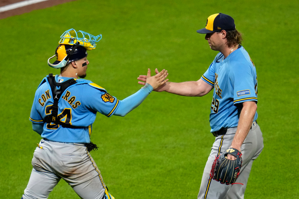 Milwaukee Brewers pitcher Trevor Megill, right, celebrates with catcher William Contreras after getting the final out of a baseball game against the Pittsburgh Pirates in Pittsburgh, Wednesday, Sept. 16, 2026. (AP Photo/Gene J. Puskar)