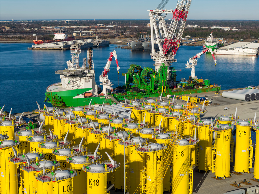 Wind turbine bases, generators and blades are positioned at The Portsmouth Marine terminal that is the staging area for Dominion Energy's wind turbine project Monday Dec. 22, 2025, in Portsmouth, Va. (AP Photo/Steve Helber)