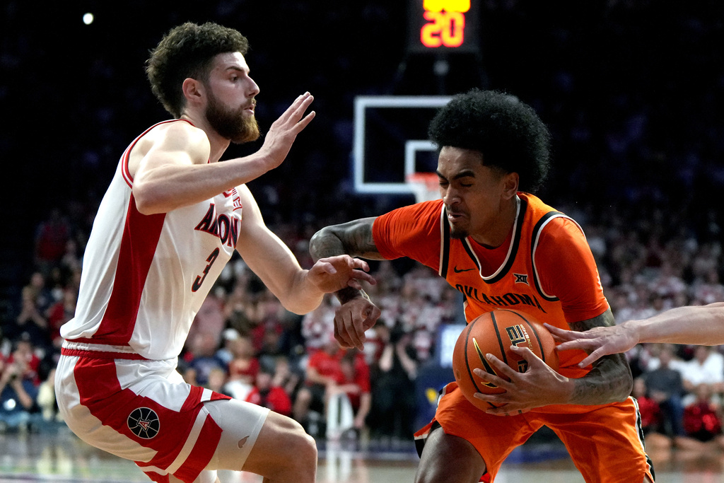 Oklahoma State guard Vyctorius Miller drives on Arizona guard Anthony Dell'orso (3) during the first half of an NCAA college basketball game, Saturday, Feb. 7, 2026, in Tucson, Ariz. (AP Photo/Rick Scuteri)