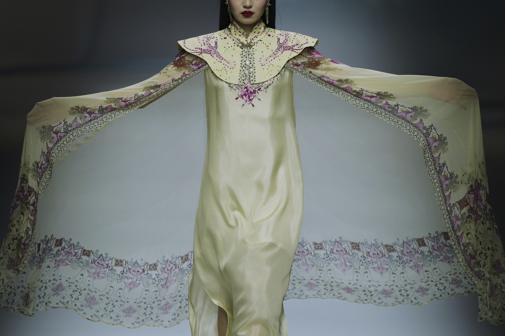 A model showcases a creation from the RU ZI ZHI YI collection by Yue Min during the SS2026 China Fashion Week, in Beijing, China, Thursday, Sept. 11, 2025. (AP Photo/Andy Wong)