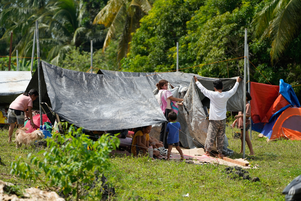 Survivors of Tuesday's earthquake build tents at open spaces on Thursday, Oct. 2, 2025 in San Remigio, Cebu Province, Central Philippines. (AP Photo/Aaron Favila)