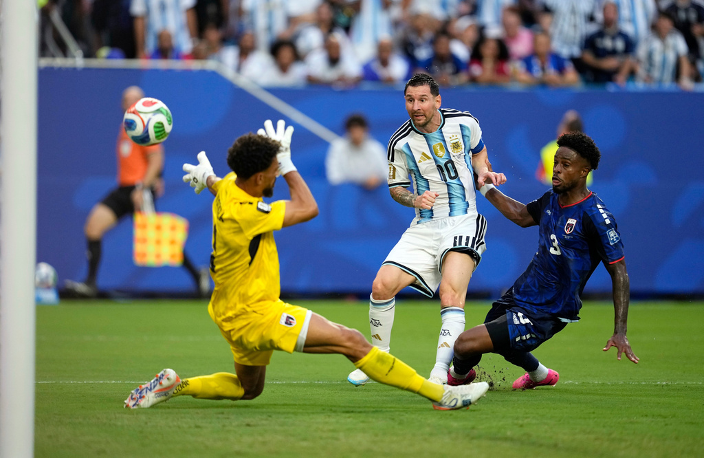 Argentina's Lionel Messi (10) scores their first goal against Cape Verde goalkeeper Vozinha (1) during the World Cup round of 32 soccer match between Argentina and Cape Verde in Miami Gardens, Fla., Friday, July 3, 2026. (AP Photo/George Walker IV)
