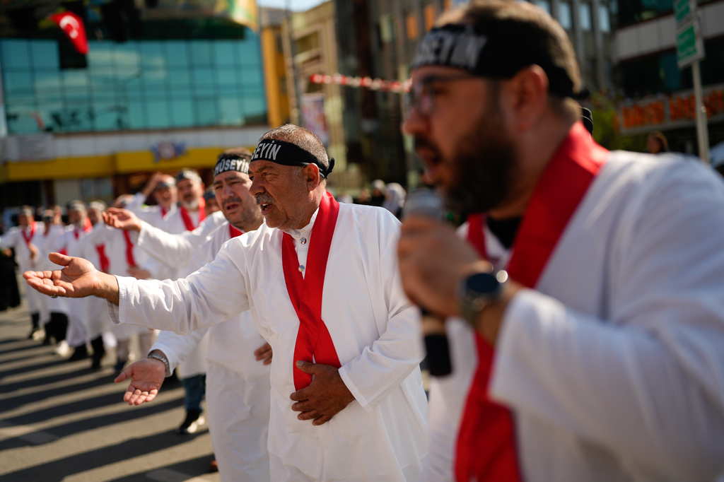 Shiite faithful Muslims attend an Ashoura procession which commemorates the 7th-century martyrdom of Imam Hussein in Istanbul, Turkey, Thursday, June 25, 2026. (AP Photo/Emrah Gurel)