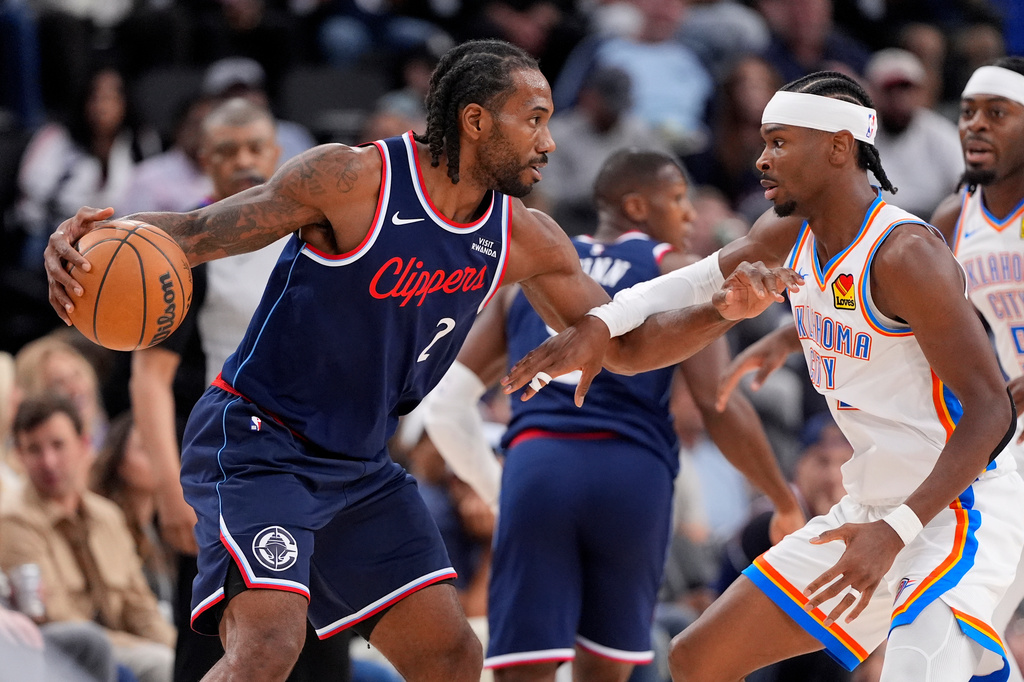 Los Angeles Clippers forward Kawhi Leonard, left, tries to get by Oklahoma City Thunder guard Shai Gilgeous-Alexander during the first half of an NBA basketball game Wednesday, April 8, 2026, in Inglewood, Calif. (AP Photo/Mark J. Terrill)
