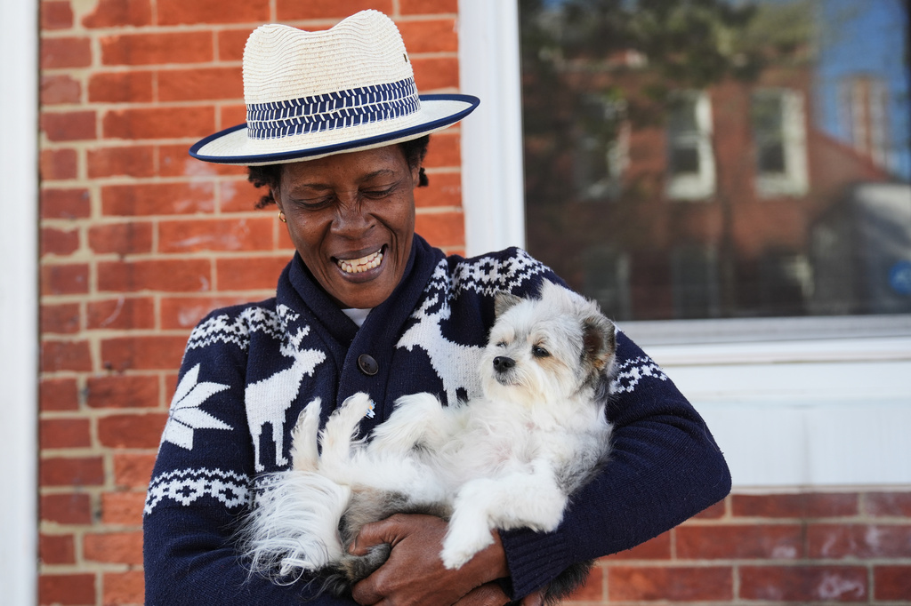 Jevona Anderson, a student at the University of Baltimore, poses for a portrait with her dog, Bella, Tuesday, April 7, 2026, in Baltimore. (AP Photo/Stephanie Scarbrough)