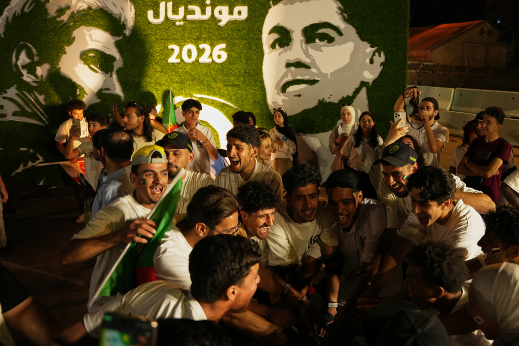 Soccer fans celebrate during the opening of the Damascus World Cup Festival, a public fan zone featuring giant screens for World Cup match broadcasts, at the Damascus Fairgrounds in Damascus, Syria, Thursday, June 11, 2026. (AP Photo/Omar Albam)