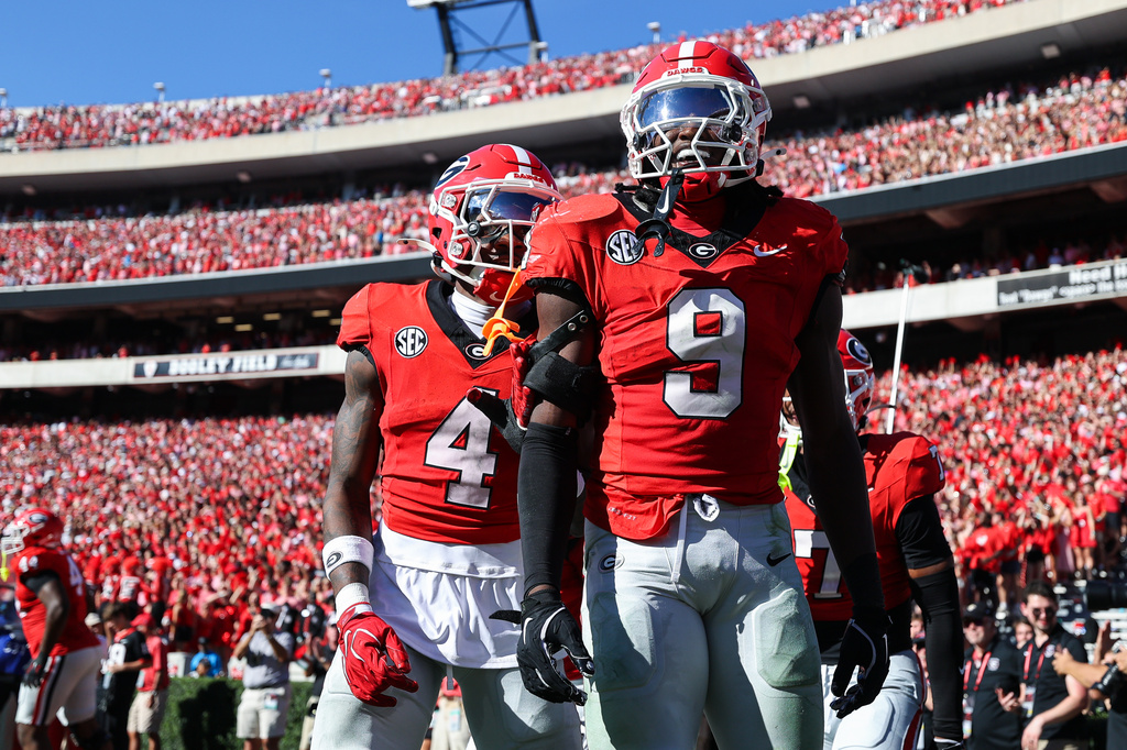 Georgia linebacker Chris Cole (9) and defensive back KJ Bolden (4) react during the first half of an NCAA college football game against Oklahoma, Saturday, Sept. 26, 2026, in Athens, Ga. (AP Photo/Colin Hubbard)
