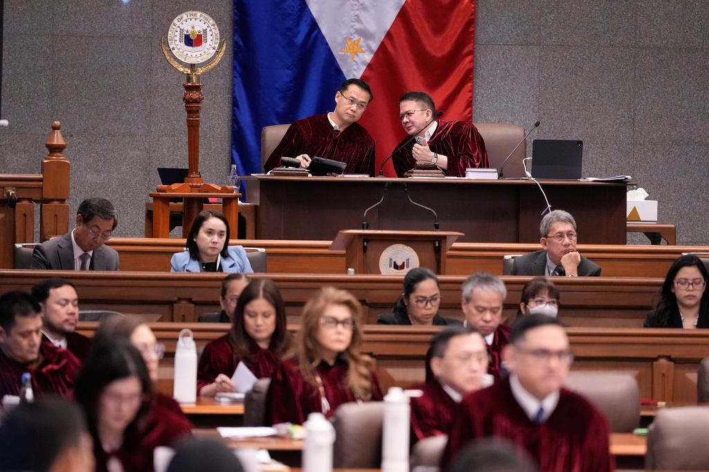 Philippine Senate President Win Gatchalian, ltop eft, and Presiding Officer Francis Escudero talk during the impeachment trial of Philippine Vice President Sara Duterte at the Philippine Senate in Pasay city, Philippines on Tuesday, July 7, 2026. (AP Photo/Aaron Favila, Pool)