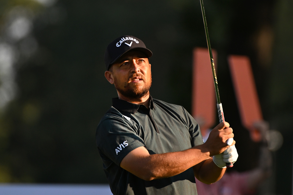 Xander Schauffele watches his shot from the 11th tee during the first round of the Rocket Classic golf tournament at the Detroit Golf Club, Thursday, July 30, 2026, in Detroit. (AP Photo/Jose Juarez)