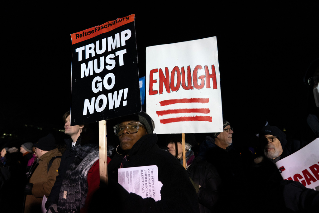 People hold up their banners during the "People's State of the Union" rally outside of the U.S. Capitol Tuesday, Feb. 24, 2026, in Washington. (AP Photo/Jose Luis Magana)