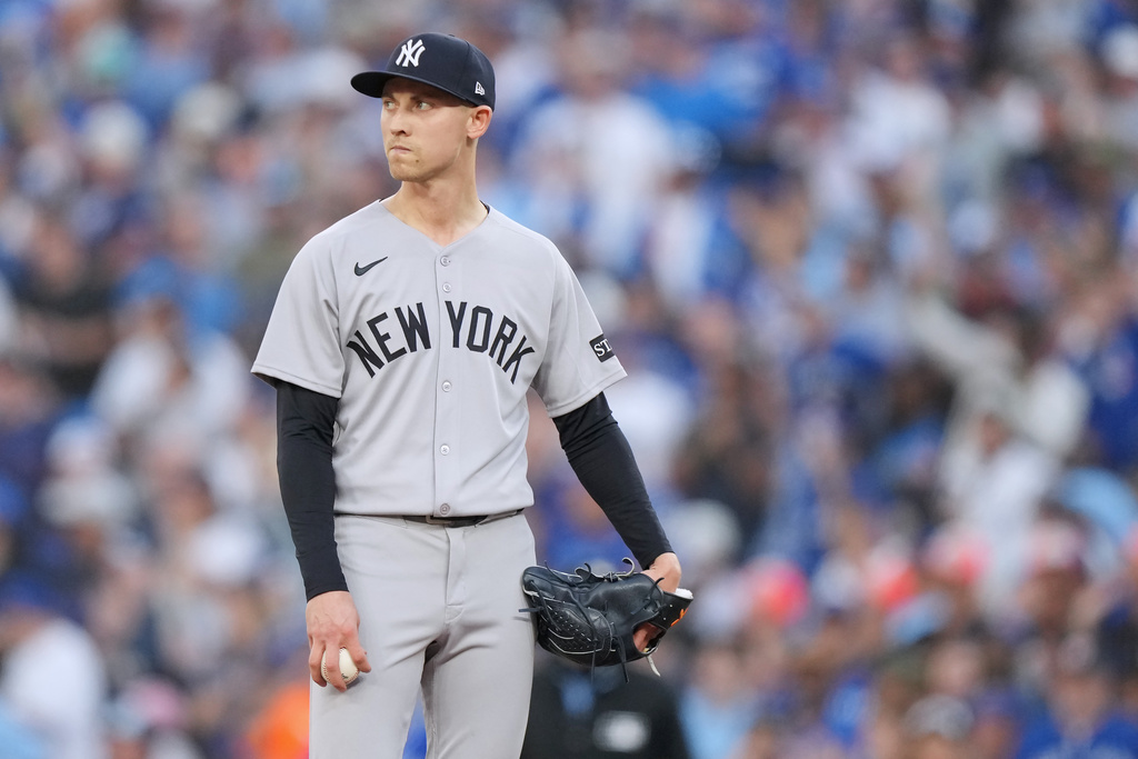 New York Yankees pitcher Luke Weaver (30) looks on after giving up an RBI single during the seventh inning against the Toronto Blue Jays in Game 1 of baseball's American League Division Series, Saturday, Oct. 4, 2025, in Toronto. (Nathan Denette/The Canadian Press via AP)